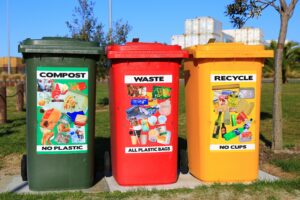 Colourful bins labelled Compost, Waste and Recycle.