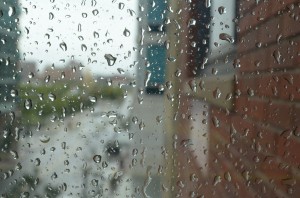 Raindrops blur a window