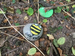 Rock painted "Bee kind"