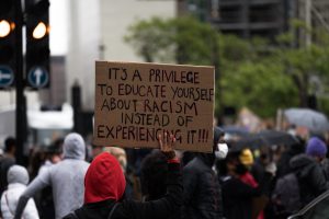 Sign: "It's a privilege to educate yourself about racism instead of experiencing it!"