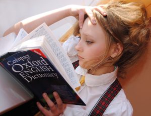 Girl reading a dictionary