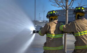 Firefighters using hose