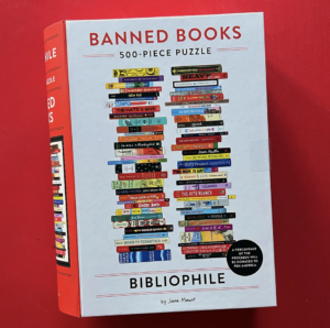 Image of a puzzle box with stacks of books labelled "Banned books."
