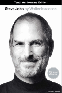 A cover of the biography of Steve Jobs showing a closeup of his face.